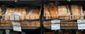 Different fresh bread on the shelves in bakery. Interior of a modern grocery store showcasing the bread aisle with a variety of