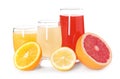 Different fresh citrus drinks in glasses and cut fruits on white background Royalty Free Stock Photo