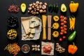 Different fresh ingredients for cooking italian pasta, spaghetti, fettuccine, fusilli and vegetables on a black Royalty Free Stock Photo