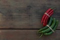 Different fresh ripe chili peppers on wooden table, flat lay. Space for text Royalty Free Stock Photo