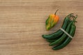 Different fresh ripe peppers on wooden table, flat lay. Space for text Royalty Free Stock Photo