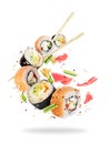 Different fresh sushi rolls with chopsticks frozen in the air Royalty Free Stock Photo