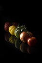 different fresh tomatoes on a black table Royalty Free Stock Photo