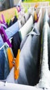 Different freshly clothes hanging with pins on the clotheshorse for drying on the balcony