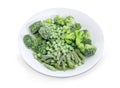 Different frozen green vegetables on the white dish closeup Royalty Free Stock Photo