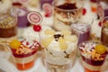 Different fruit desserts with fruits in glasses on the table. Restaurant presentation, food, party concept