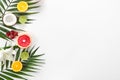 Different fruits and palm leaf on white background Royalty Free Stock Photo