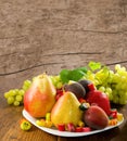 different fruits and sweets on wooden table close-up Royalty Free Stock Photo