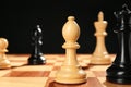 Different game pieces on chessboard against dark background