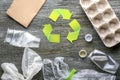 Different garbage with symbol of recycling on wooden background. Ecology concept Royalty Free Stock Photo