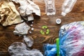 Different garbage with symbol of recycling on wooden background. Ecology concept Royalty Free Stock Photo