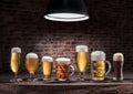 Different glasses of beer on the wooden table. Royalty Free Stock Photo