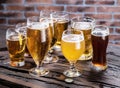 Different glasses of beer on the wooden table