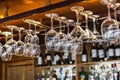 Different glasses hanging over the bar. Soft focus. selective focus Royalty Free Stock Photo