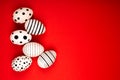 Different graphic hand-painted eggs on bright red background. Royalty Free Stock Photo