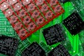 Different green, red and black printed circuit borads on top of each other