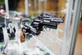 Different guns and revolvers on shelves store weapons on shop ce Royalty Free Stock Photo