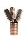 Different hair brushes and comb in holder isolated Royalty Free Stock Photo