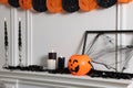 Different Halloween decor near white wall indoors