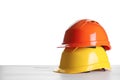 Different hard hats on wooden table against white background. Space for text Royalty Free Stock Photo