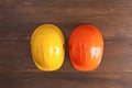 Different hard hats on wooden table, flat lay