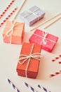 Different holiday colorful gift boxes wrapped in colorful paper and bows on beige background Royalty Free Stock Photo