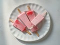 Different homemade ice cream popsicles over a plate. Generative AI