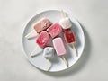 Different homemade ice cream popsicles over a plate. Generative AI