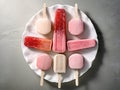 Different homemade ice cream popsicles over a plate. Generative AI