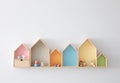 Different house shaped shelves with toys on wall. Interior design