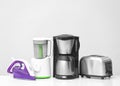 Different household and kitchen appliances on table against light background. Interior element Royalty Free Stock Photo