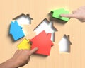 Different houses suit house shape holes board with hands assembl Royalty Free Stock Photo