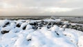 different ice formations on rocks on the seashore, ice texture, wind, water and ice working together Royalty Free Stock Photo