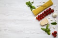 Different ingredients for cooking italian pasta on a white wooden background, top view. Flat lay. Royalty Free Stock Photo