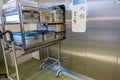 Some different instrument containers are pushed into a sterilization unit