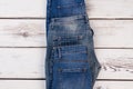 Different jeans on wooden background