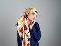 Different kind of beauty. Studio portrait of a confident young woman wearing a colorful head scarf while posing against Royalty Free Stock Photo