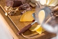 The different kind of cheese and walnuts on wooden background