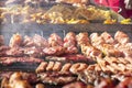 Different kind on grilled meat, sausages and fried potatoes with smoke Royalty Free Stock Photo
