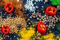 Different kind of spices and herbs and chili on a black stone background Royalty Free Stock Photo