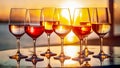 Different kind of wine in glasses on table on blurred seascape sunset background