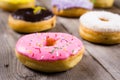 Different kinde of round donuts on wooden table. Closeup Royalty Free Stock Photo