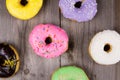 Different kinde of round donuts on wooden table. Top view Royalty Free Stock Photo