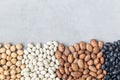 Different kinds of beans: black, pinto, white and chickpeas, on a concrete background, copy space, horizontal Royalty Free Stock Photo