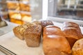 Different kinds of bread on the counter in the bakery shop. Fresh bread counter. Modern bakery with different kinds of