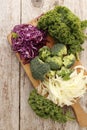 Different kinds of cabbage on a wooden board