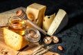 Different kinds of cheese with nuts and honey Royalty Free Stock Photo