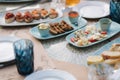 Different kinds of cheeses on served table at summer terrace in cafe. Food concept. Different kind of food on the table Royalty Free Stock Photo