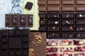 Different kinds of chocolate bars laying down on vintage wooden background.