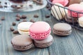 Different kinds of colorful french dessert macaron with different fillings on table, served with coffee, horizontal
